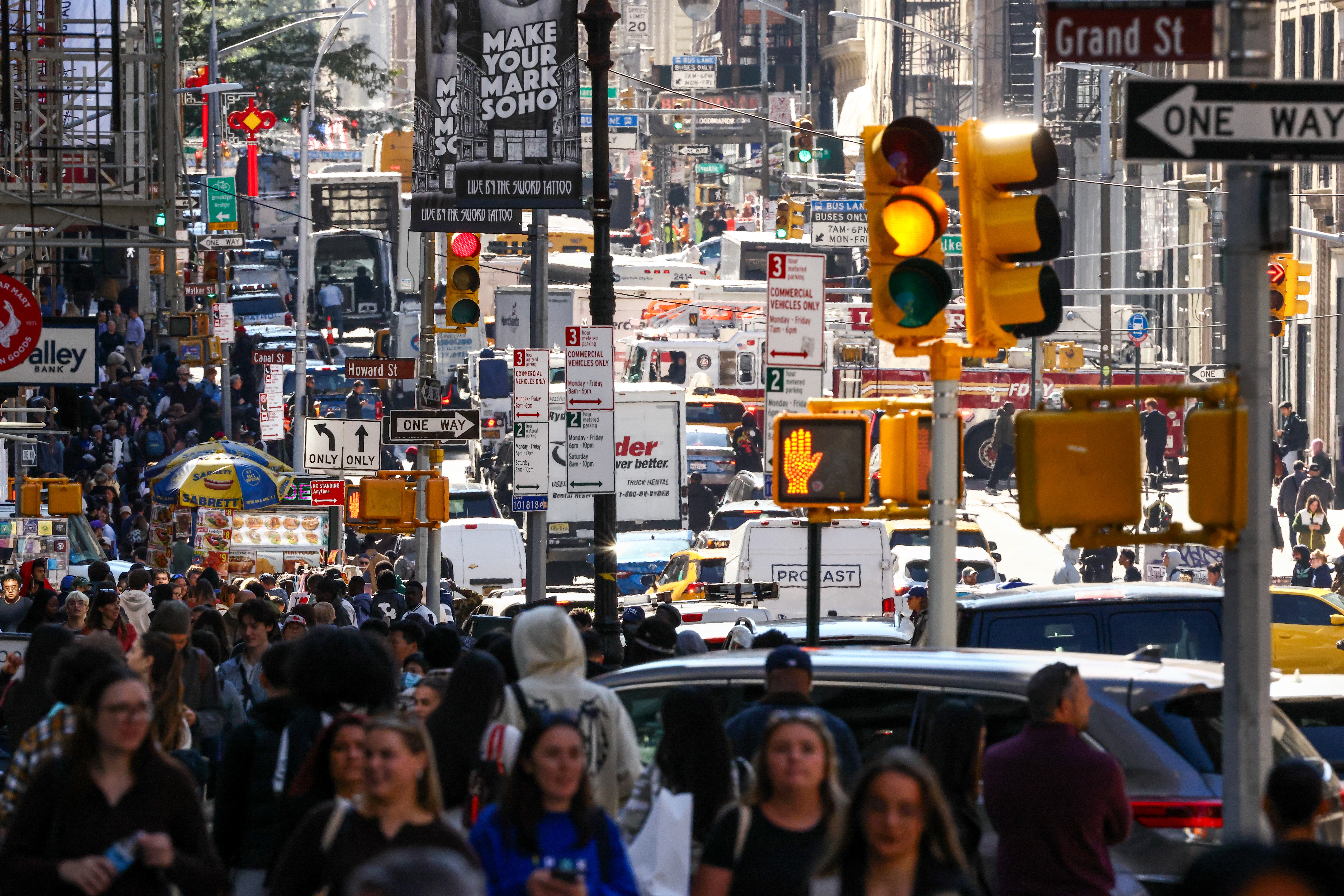 A long-lens view of a busy and crowded street in New York City.
