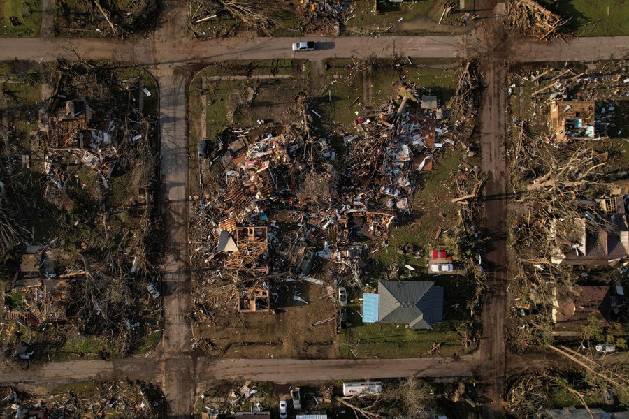 An aerial view of a heavily damaged neighborhood, after a tornado hit
