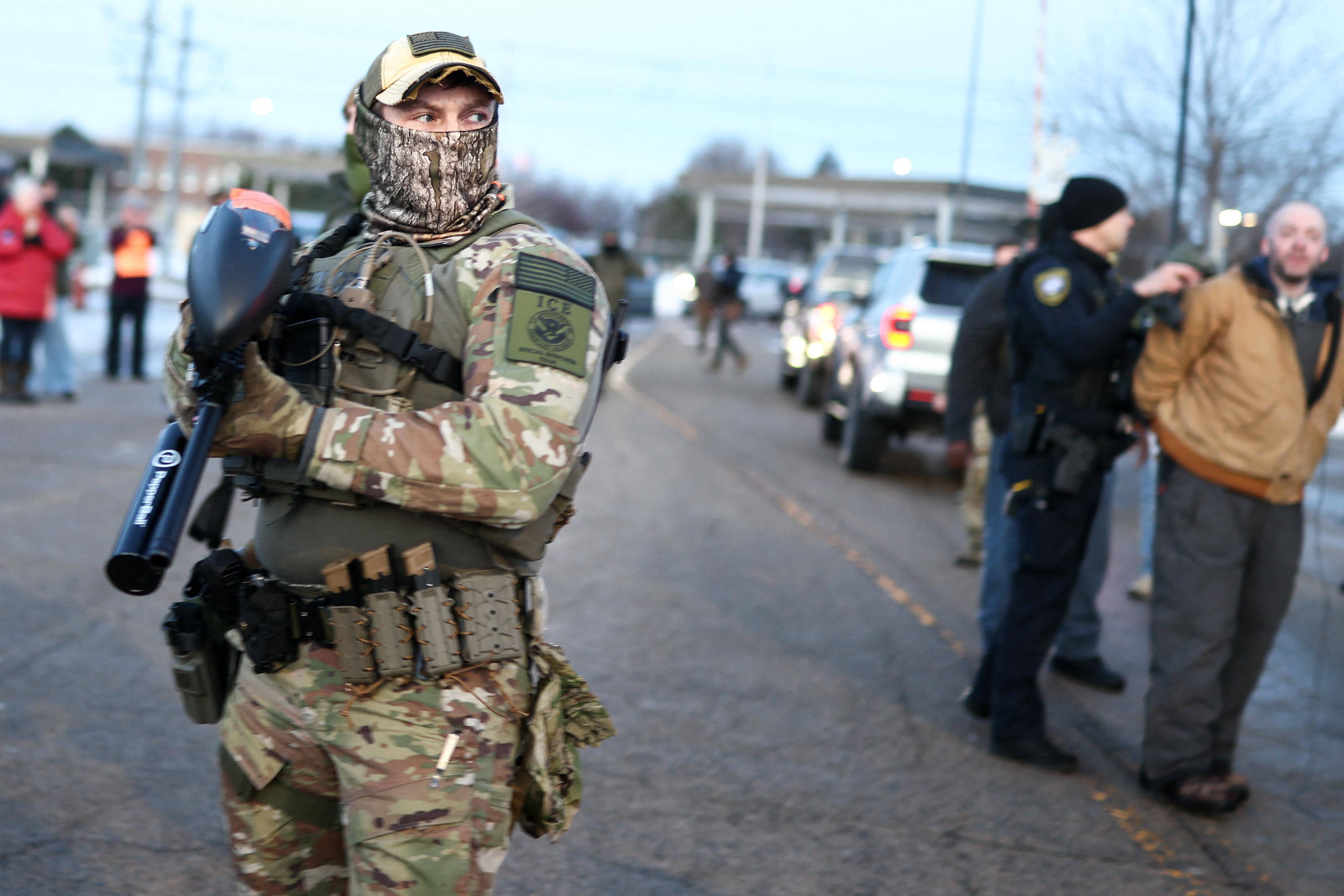 An ice agent with a 'pepperball' projectile launcher