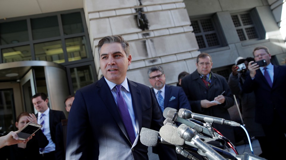 Jim Acosta talks to reporters after a judge temporarily restored his White House press credentials.