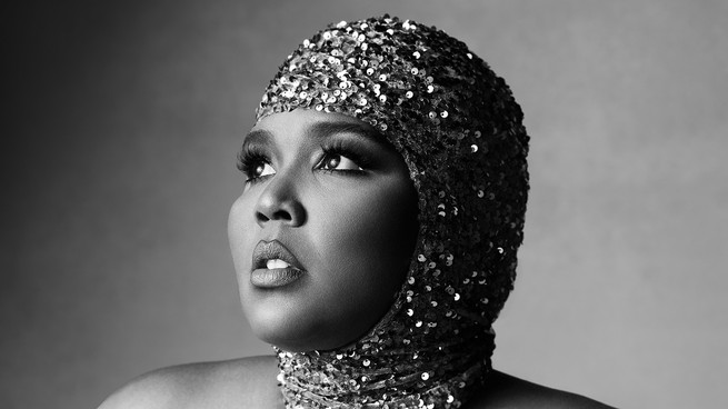 Black-and-white portrait of Lizzo in a sequined cap