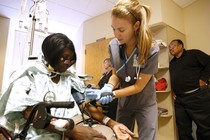 Nurse checks patient's vitals