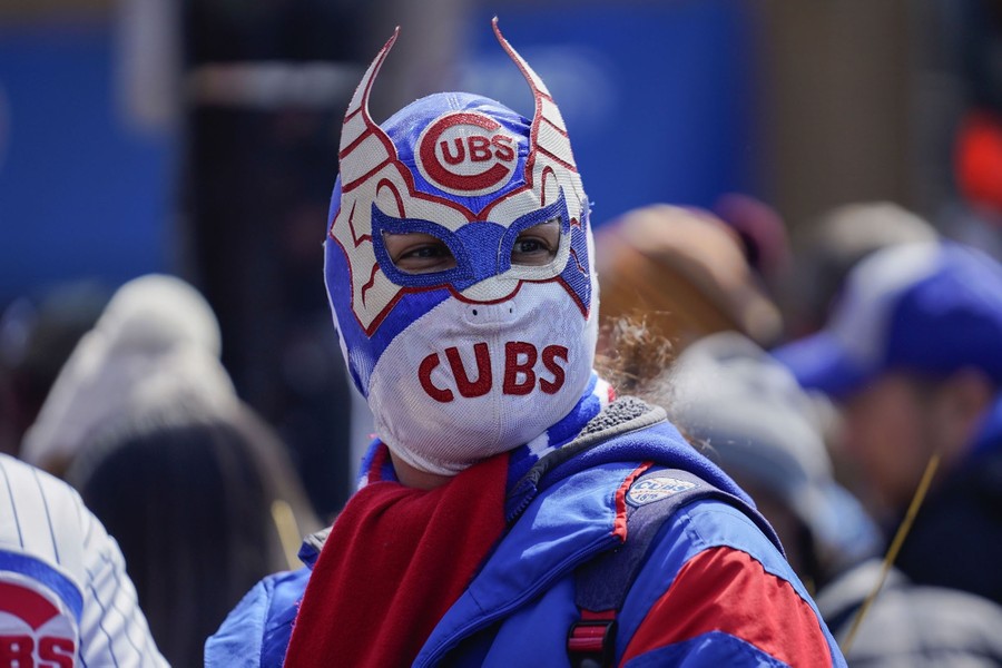 A fan wears a Cubs-themed luchador mask.