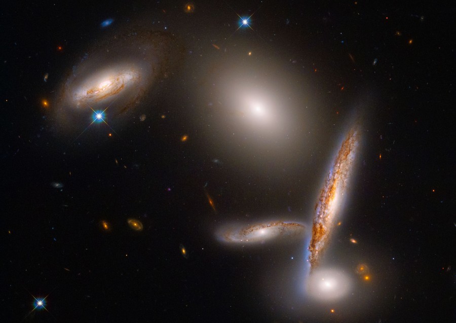 Five distinct galaxies are seen clustered close together.
