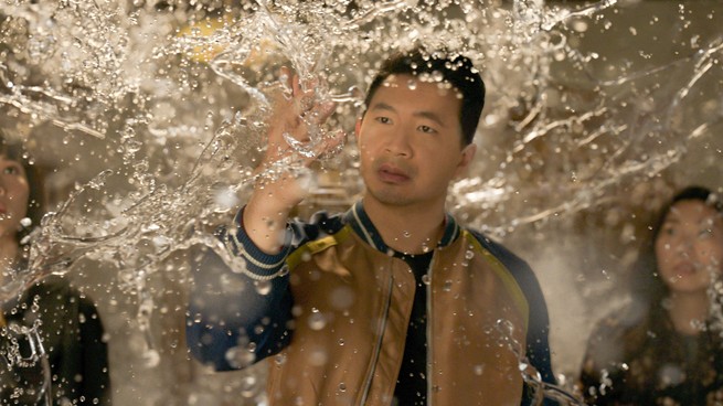 Simu Liu touching water in the air
