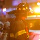 A firefighter in front of a fire engine