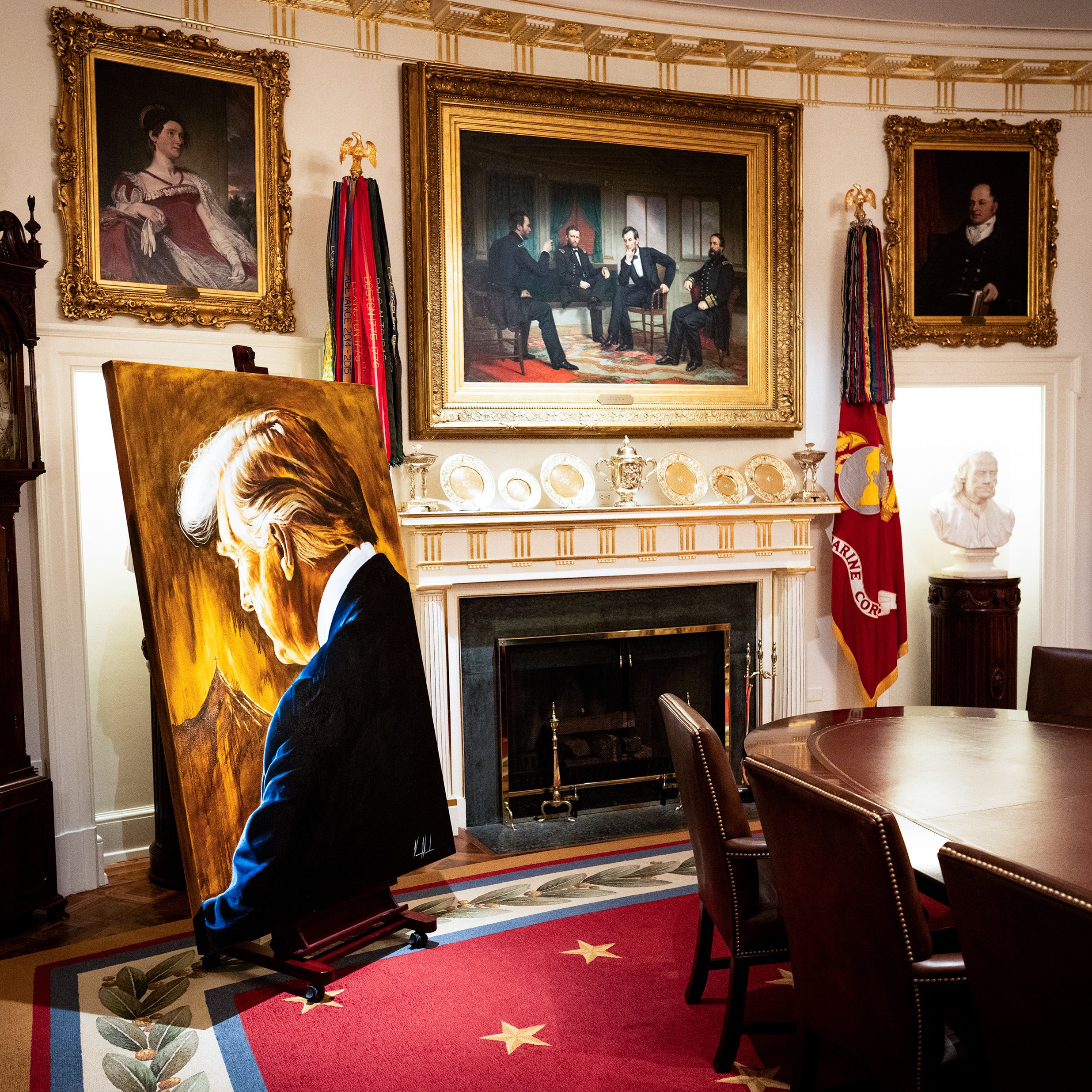 A painting of President Donald Trump by Vanessa Horabuena, left, is displayed in the Cabinet Room of the White House 