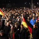 Participants hold German national flags during a demonstration called by anti-immigration group Pegida, a German abbreviation for "Patriotic Europeans against the Islamization of the West", in Dresden on December 15, 2014.