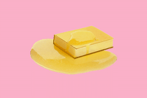 A golden book with a pat of butter melting on top of it, resembling a pancake