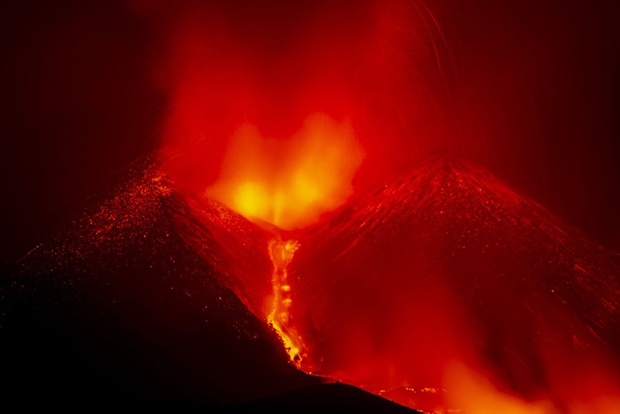 A night view of an erupting volcano.