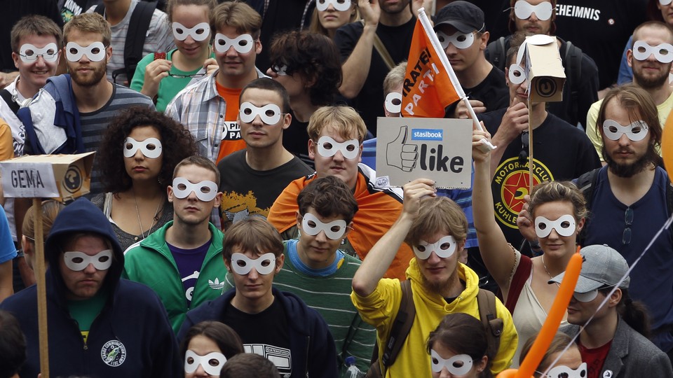Protestors wearing masks at a rally for digital privacy in Berlin
