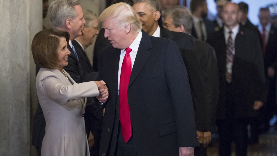 Donald Trump shakes hands with Nancy Pelosi.