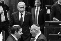 Israeli Prime Minister Benjamin Netanyahu walks at the plenum in the Knesset, Israel's Parliament.