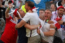 England soccer fans embrace and celebrate.