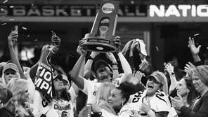 A photo of the University of South Carolina women's basketball team hoisting the NCAA championship trophy