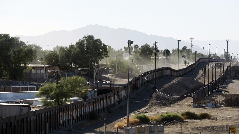 A wall bisects a sandy area