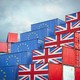 Shipping containers painted with the European flag and the Union Jack sit next to each other.