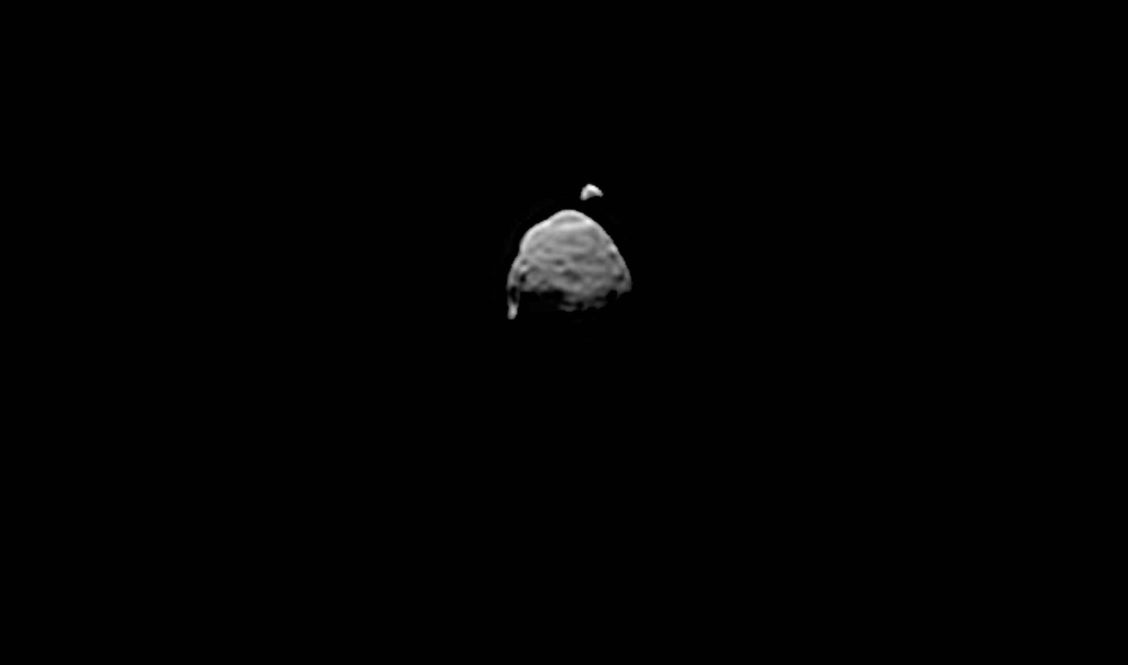 A view of two small, irregularly-shaped moons in space