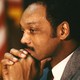 Photograph of Jesse Jackson with his head resting on his hands.