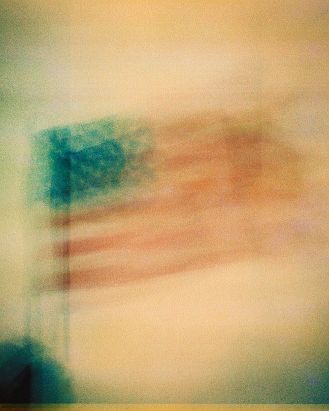 A blurry American flag waving