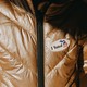 An "I Voted" sticker on a golden puffer jacket