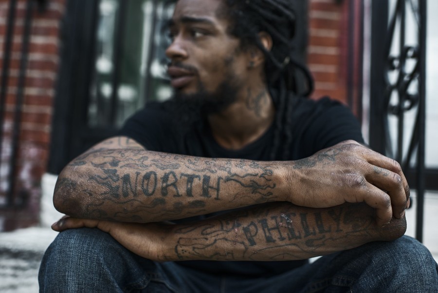 Jamil Prattis, 25, sits in front of his house on French Street in North Philadelphia on Friday May 23, 2014.