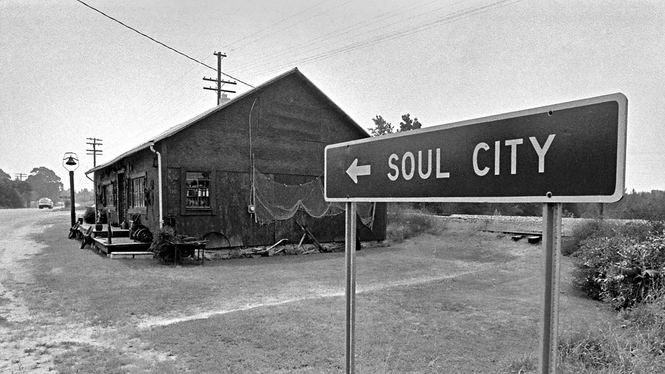Sign to Soul City next to house