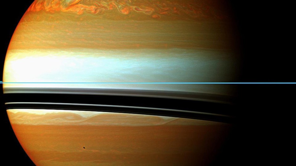 NASA handout image shows Saturn's atmosphere and its rings in a false color composite made from 12 images taken from the Cassini aircraft, captured on January 12, 2011.