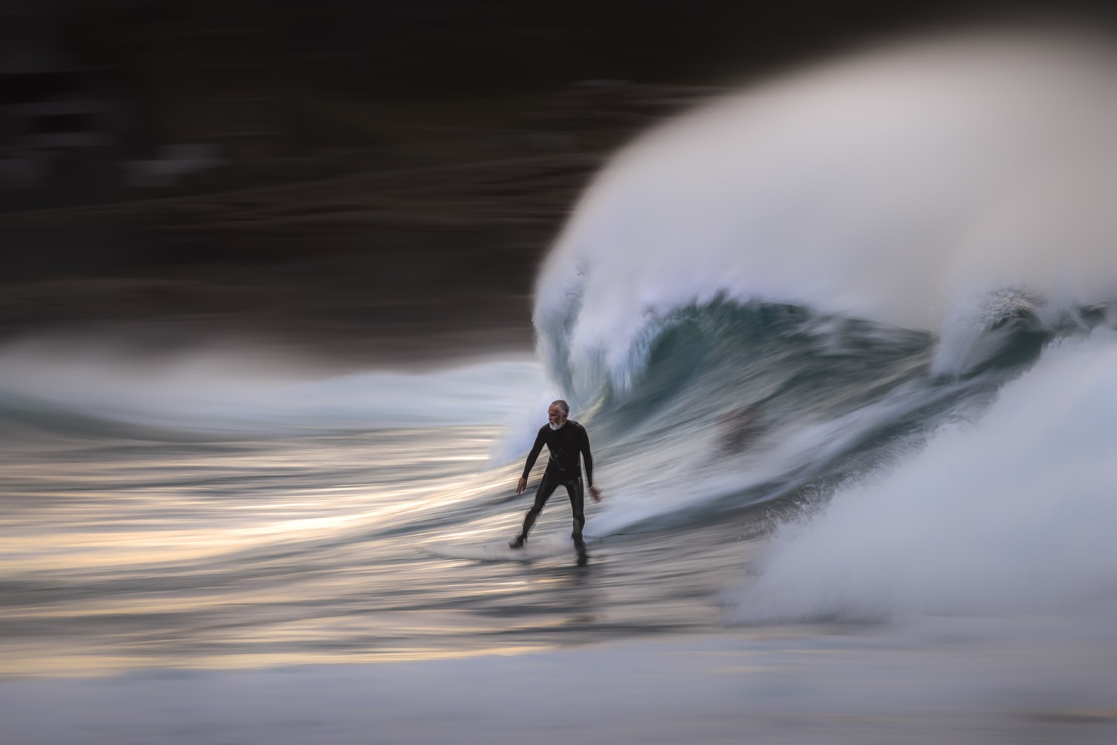 A blurred-motion photo of a man surfing