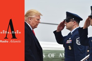 Donald Trump stands in front of two people in military uniforms who are saluting