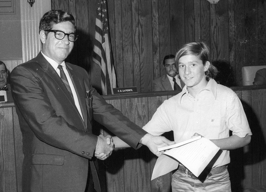 A young Michael Flynn shaking hands with a city official
