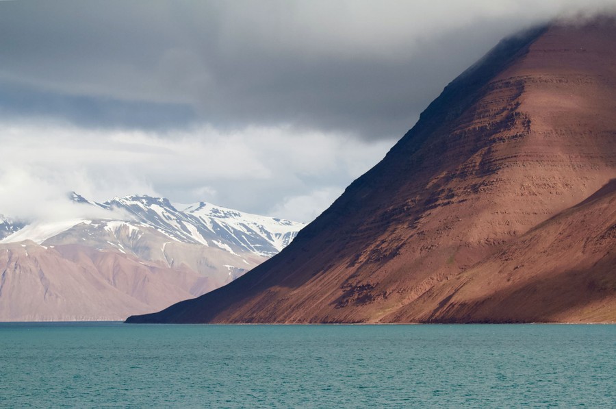 A view of mountains and blue-green water