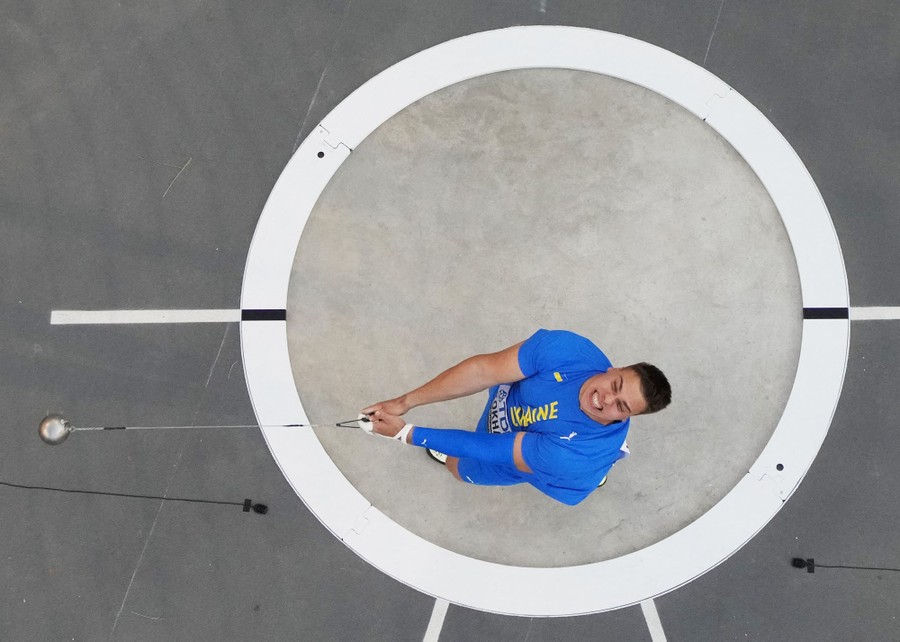 A top-down view of an athlete spinning while holding a hammer before releasing it.