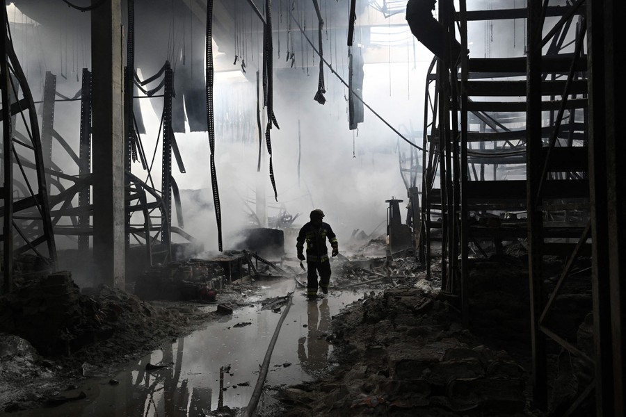 A firefighter walks amid the ruins of a shopping mall.