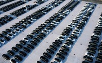 rows of hundreds of black and white cars