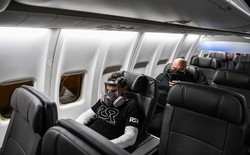 A man wears a gas mask as he travels on a flight from Miami to Atlanta on April 23, 2020.