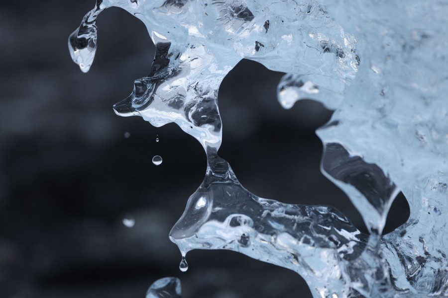 Water drips from melting ice of an iceberg.