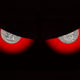 An illustration showing a pair of evil-looking eyes with coins for pupils