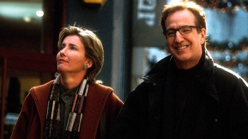 A scene from the movie "Love Actually," featuring Emma Thompson and Alan Rickman walking down a city street.