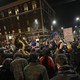 A crowd of protesters, including some with signs and one with a tuba, fill the streets in Berkeley, California, protesting a speech by Milo Yiannopoulos