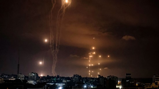 Rockets fired by Palestinian militants from Gaza City are intercepted by the Israeli Iron Dome defence missile system on October 7 2023