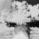 An animation depicting a loading bar on top of an image of a mushroom cloud