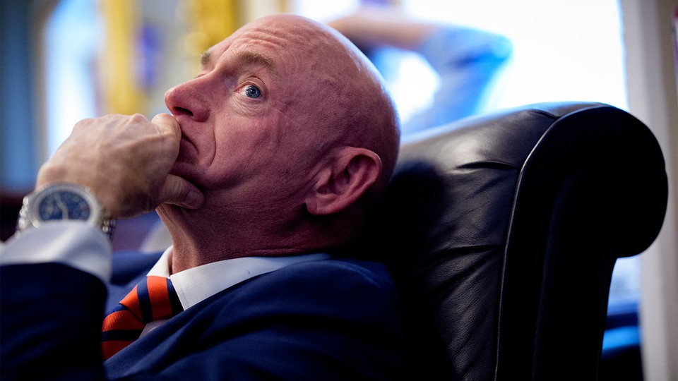 Photograph of Mark Kelly leaning back in a leather chair with his chin resting in his hand
