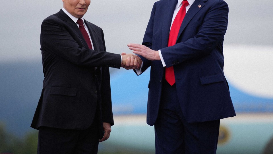 Color photo of Donald Trump and Vladimir Putin shaking hands, with their heads cropped out