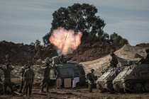 Photo of Israeli soldiers around a mortar launcher firing toward Gaza from Be'eri, Israel, on Tuesday, October 17, 2023.