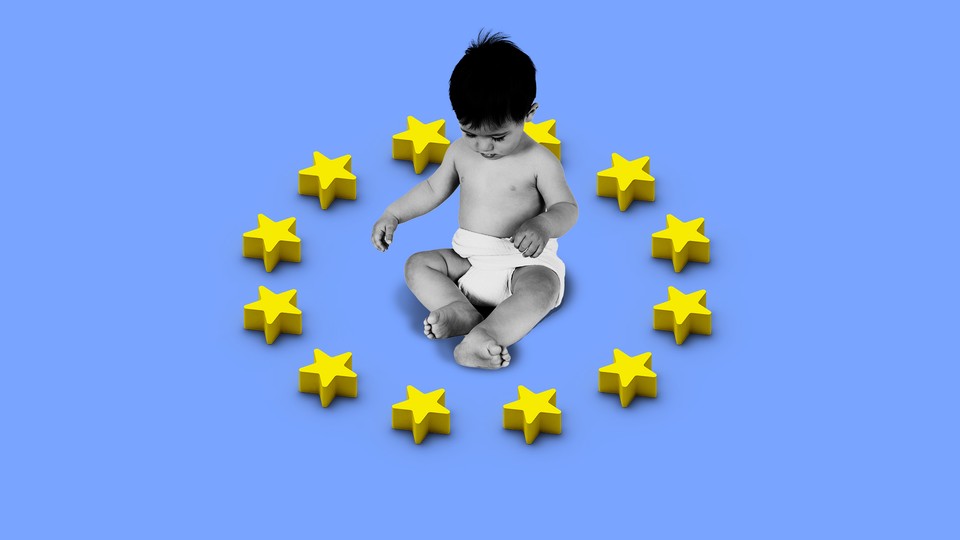 a baby sitting inside a representation of the EU flag as toy star blocks