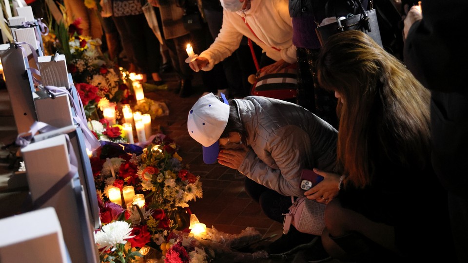 People pay tribute at a candlelight vigil in front of City Hall in Monterey Park
