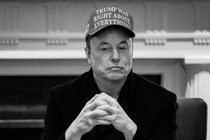 A photo of Elon Musk sitting in a Cabinet meeting, wearing a hat that reads: "Trump was right about everything."