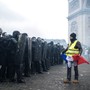 A protester stands in front of riot police at the Arc de Triomphe on January 12.