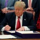 Donald Trump signs the First Step Act and the Juvenile Justice Reform Act in the Oval Office on December 21, 2018.